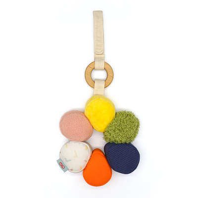 Colorful baby teething ring with various textures on a white background