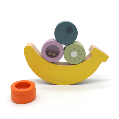 Colorful wooden toy banana with round pieces on a white background